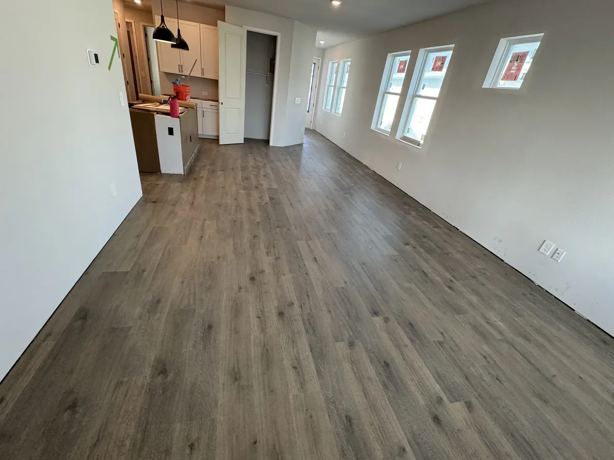 Living room and kitchen with new wood flooring installed